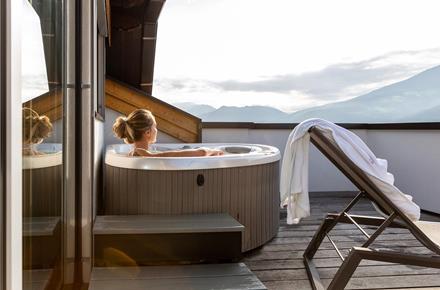 A woman in the whirlpool on the terrace of the Panorama Suite